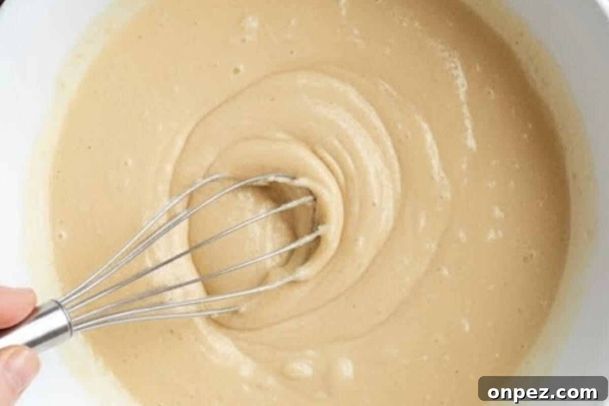 Make a well in the center and pour in the oil, egg, vanilla, and milk.