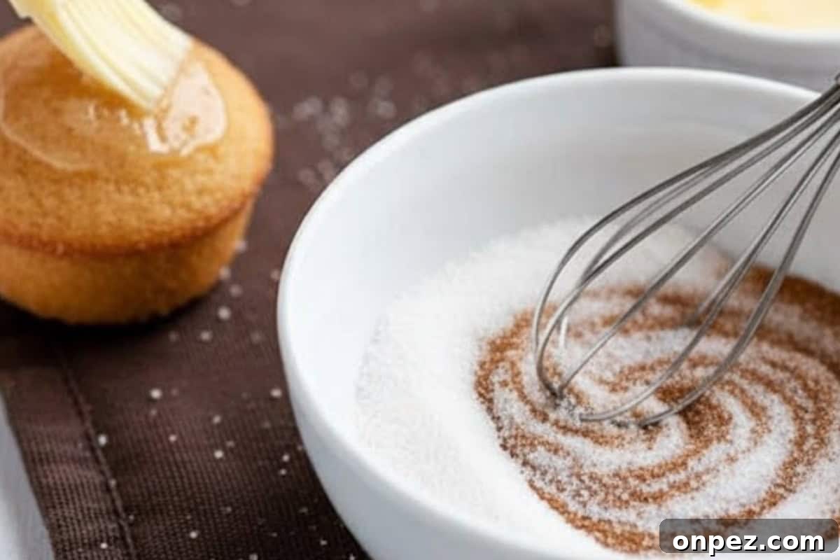 In a shallow bowl, mix the sugar and cinnamon together. Brush each warm donut lightly with melted butter