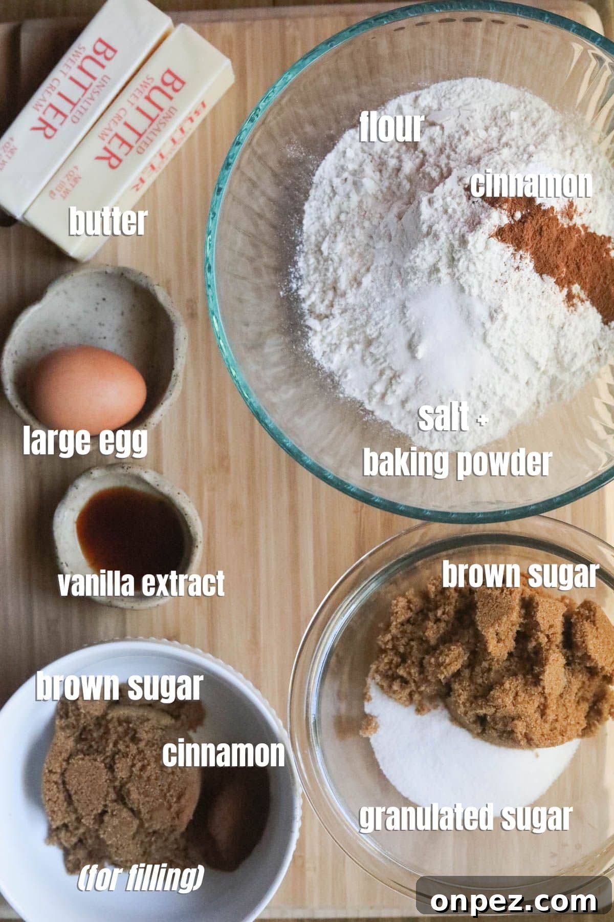 cinnamon roll ingredients spread out on a cutting board.