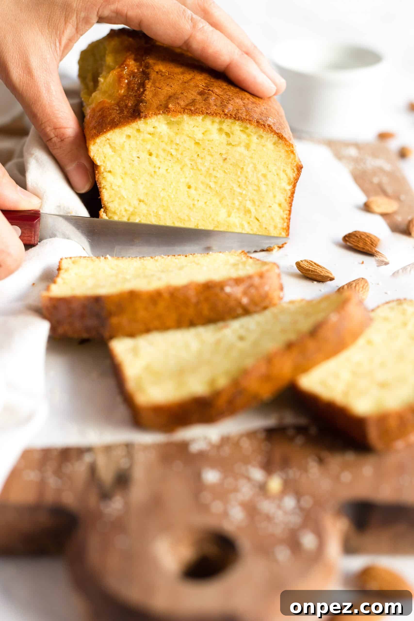 Slicing into a loaf of almond bread.