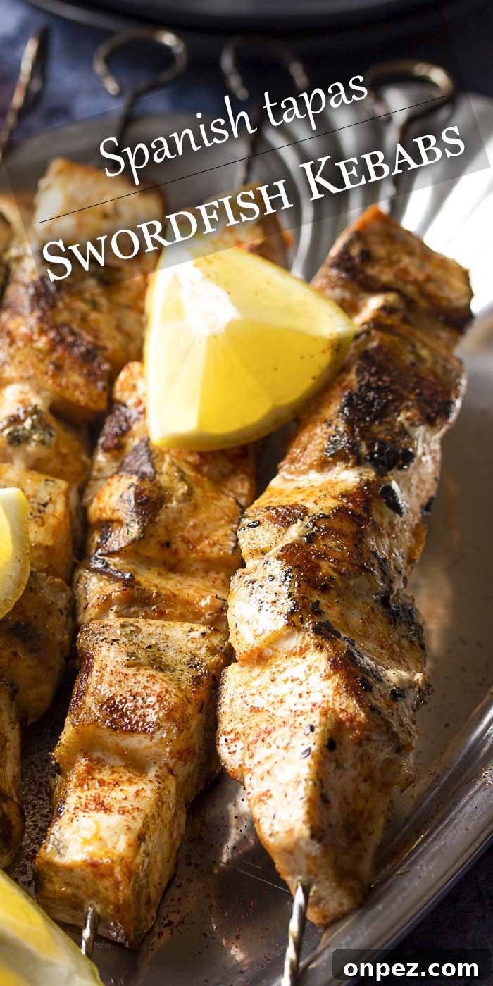 Cubed grilled fish on skewers - Swordfish Kebabs. Cubed grilled fish on skewers with text overlay - Swordfish Kebabs.