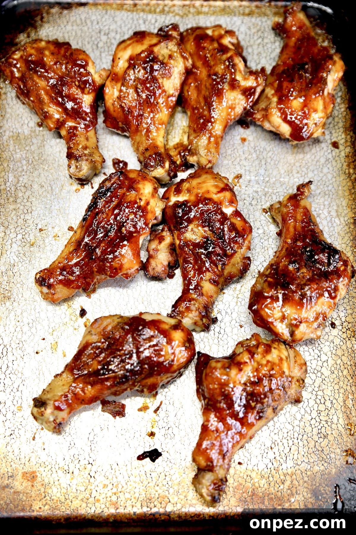 Sheet pan of bbq chicken legs.