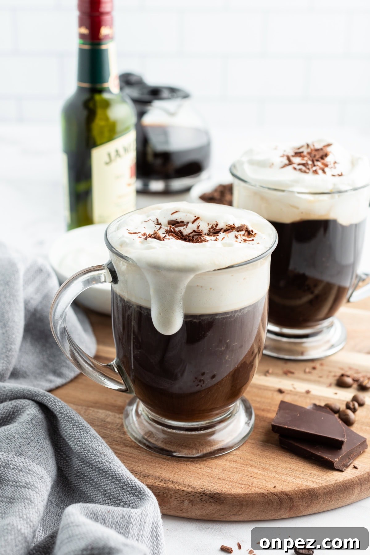 How to Make Irish Coffee whipped cream dripping down side of mug of irish coffee