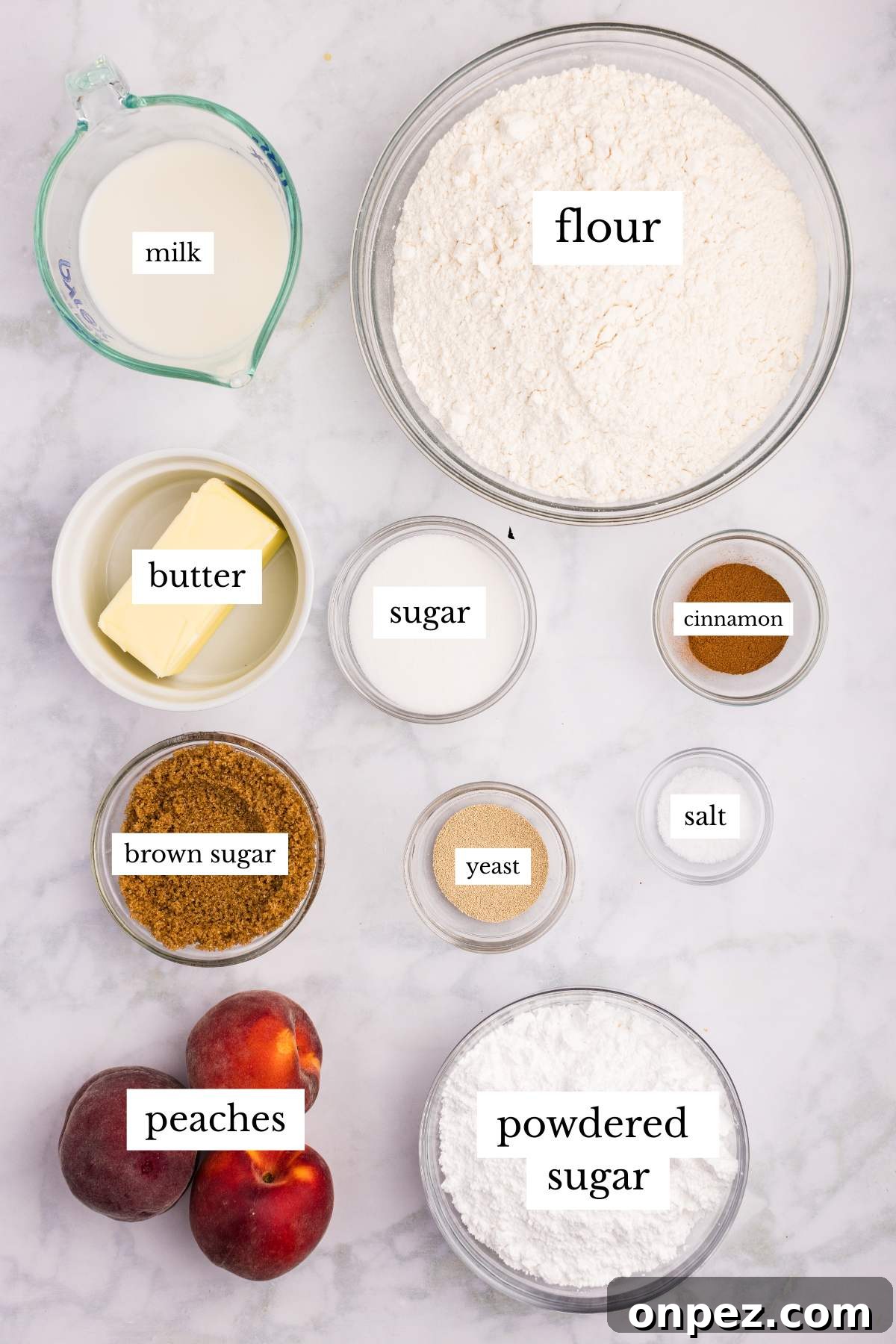 Overhead view of labeled ingredients for peach cobbler cinnamon rolls.