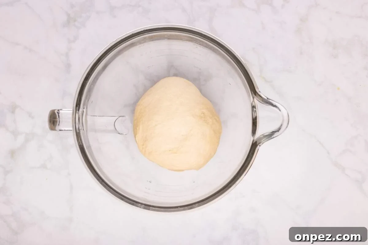 Ball of dough in a glass mixing bowl.