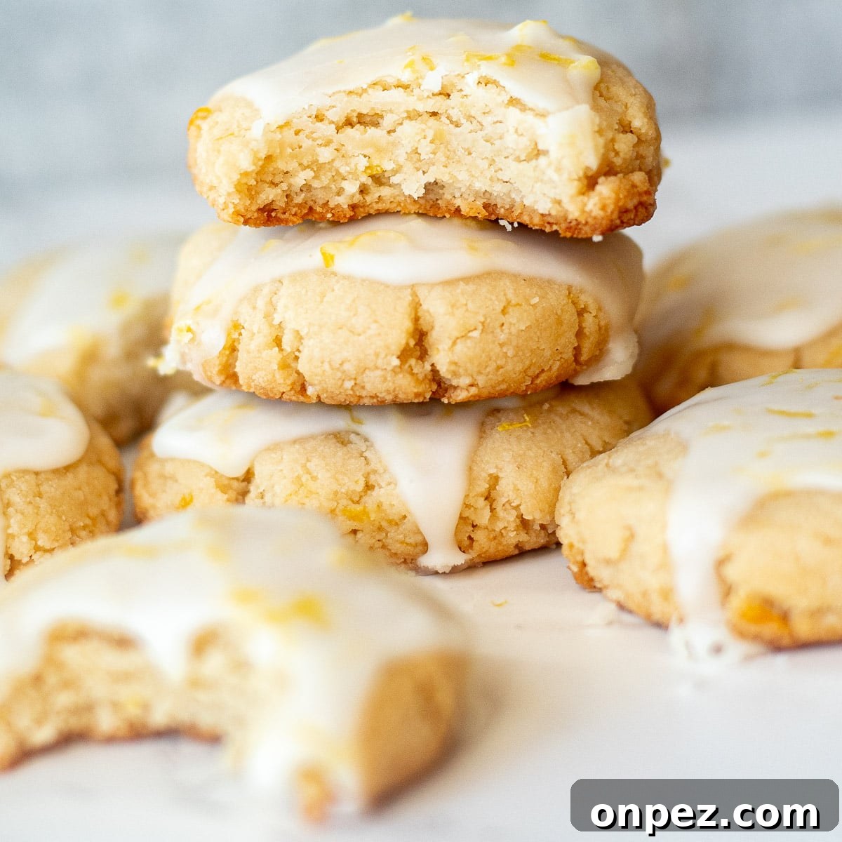 stack of vegan lemon cookies with icing