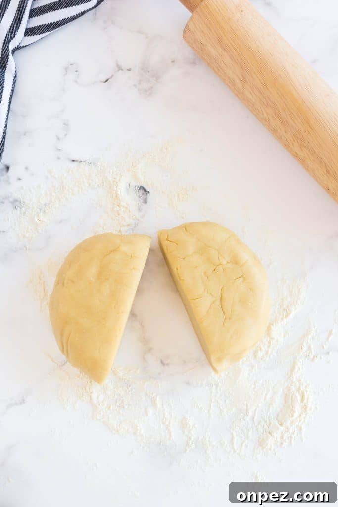 Perfect Homemade Pie Crust Recipe: Flaky and Foolproof 11 a disk of dough cut in half.