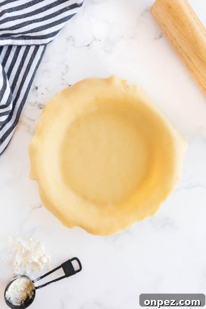 Perfect Homemade Pie Crust Recipe: Flaky and Foolproof 13 pie crust dough in a pie dish.