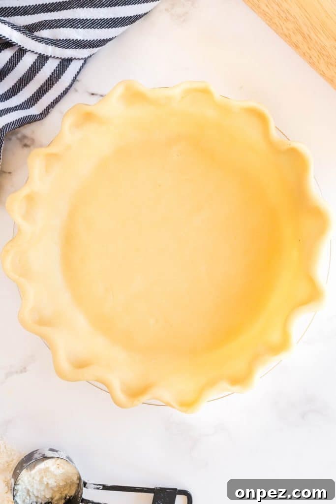 Perfect Homemade Pie Crust Recipe: Flaky and Foolproof 15 pie crust dough over a pie dish.
