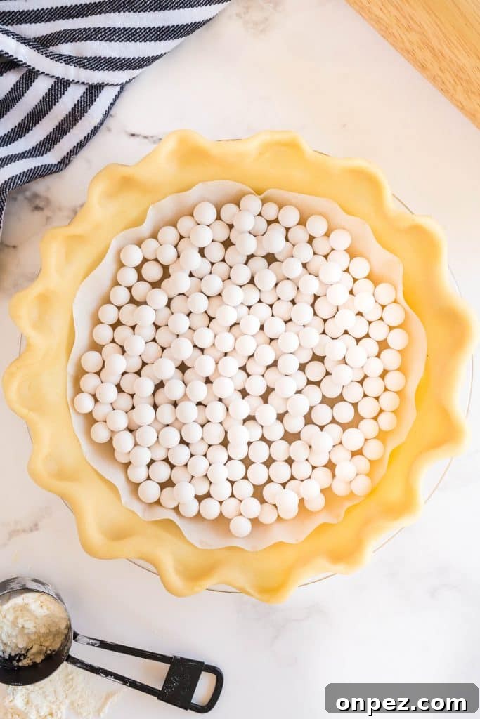 Perfect Homemade Pie Crust Recipe: Flaky and Foolproof 17 white pie weights over the pie dough
