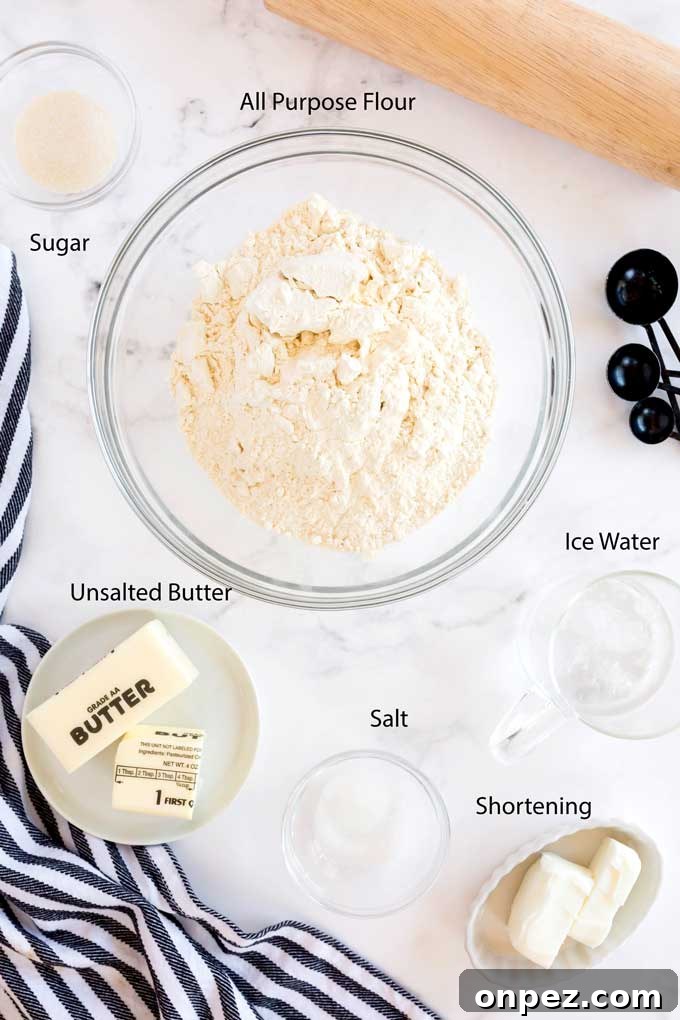 Perfect Homemade Pie Crust Recipe: Flaky and Foolproof 4 Ingredients to make pie dough on a white marble counter.