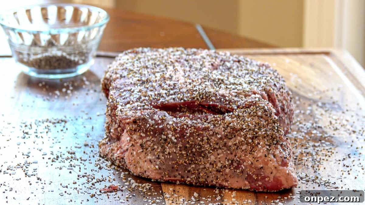 Budget Burnt Ends: Incredibly Tender Brisket Bites 3 Beef chuck roast covered in salt and pepper on cutting board with seasoning dish