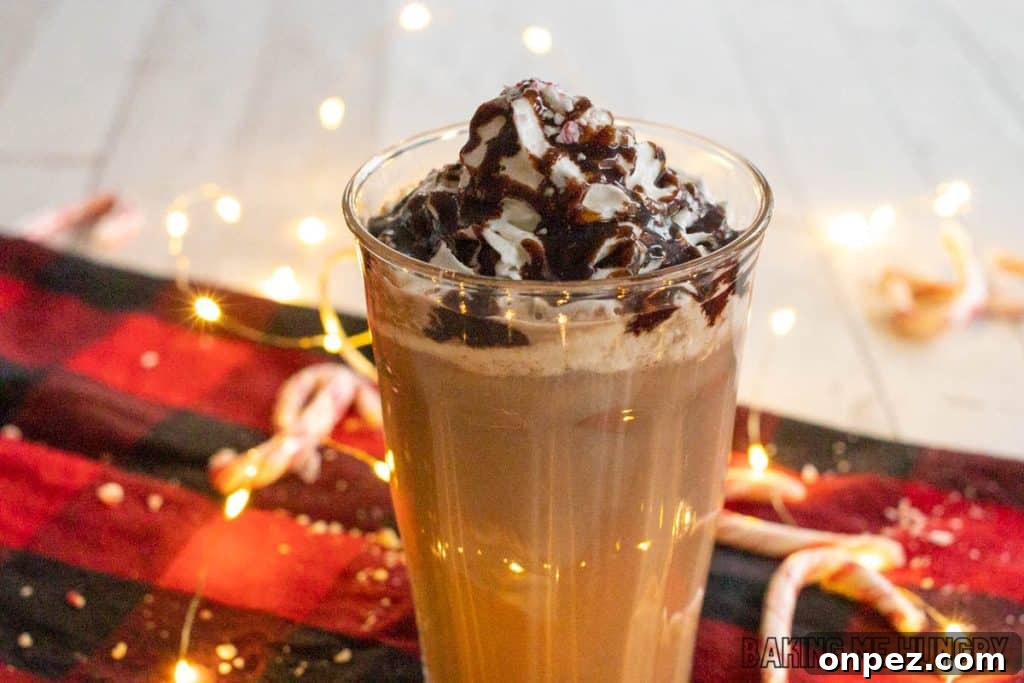 Iced Peppermint Mocha Recipe: Mint Chocolate Coffee 3 iced peppermint mocha glass in front of twinkle lights