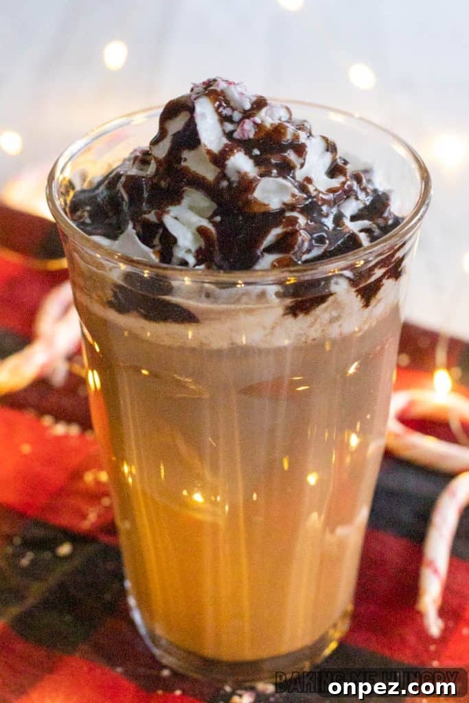 Iced Peppermint Mocha Recipe: Mint Chocolate Coffee 8 iced peppermint mocha in a glass close up in front of twinkle lights