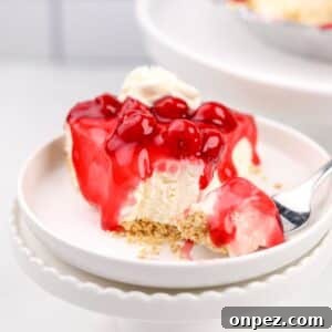A slice of cheesecake topped with a cherry glaze.