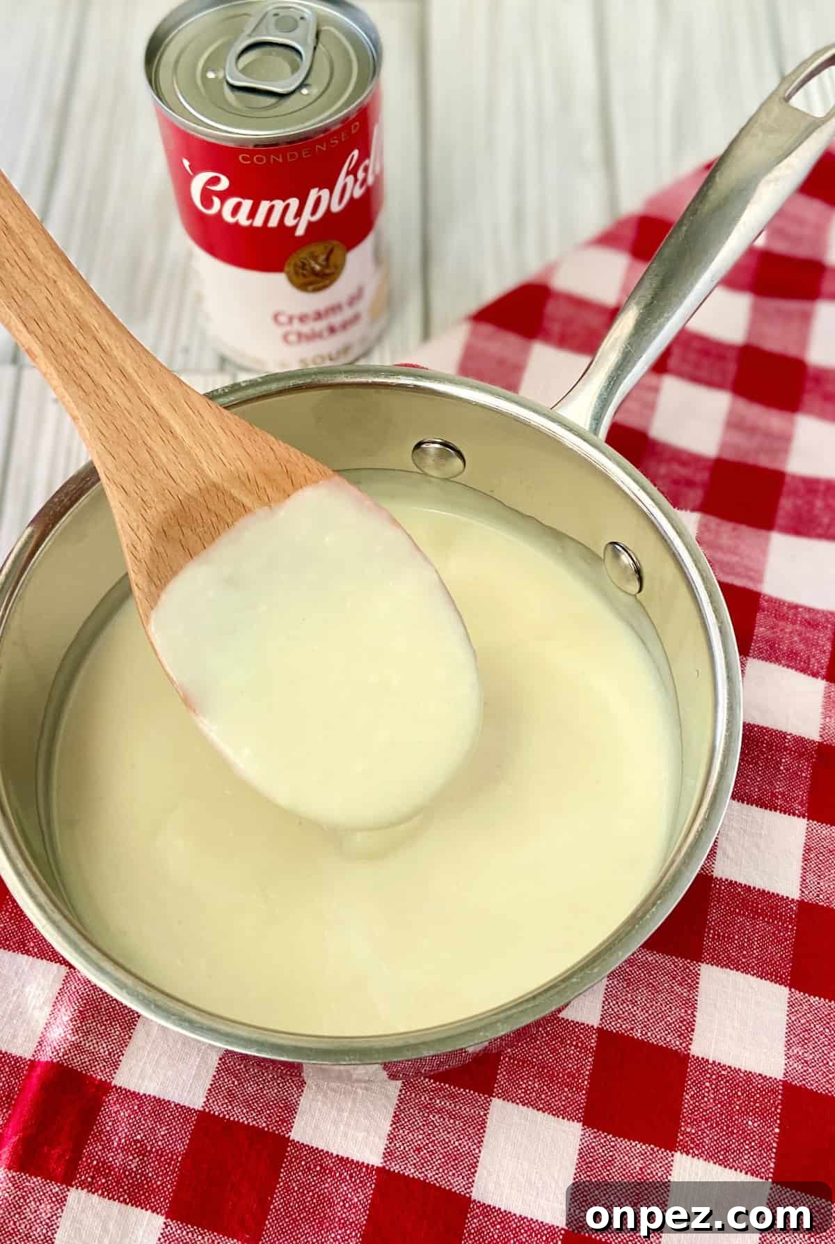 Condensed Cream of Chicken Soup from Scratch 2 Condensed cream of chicken soup on wooden spoon.