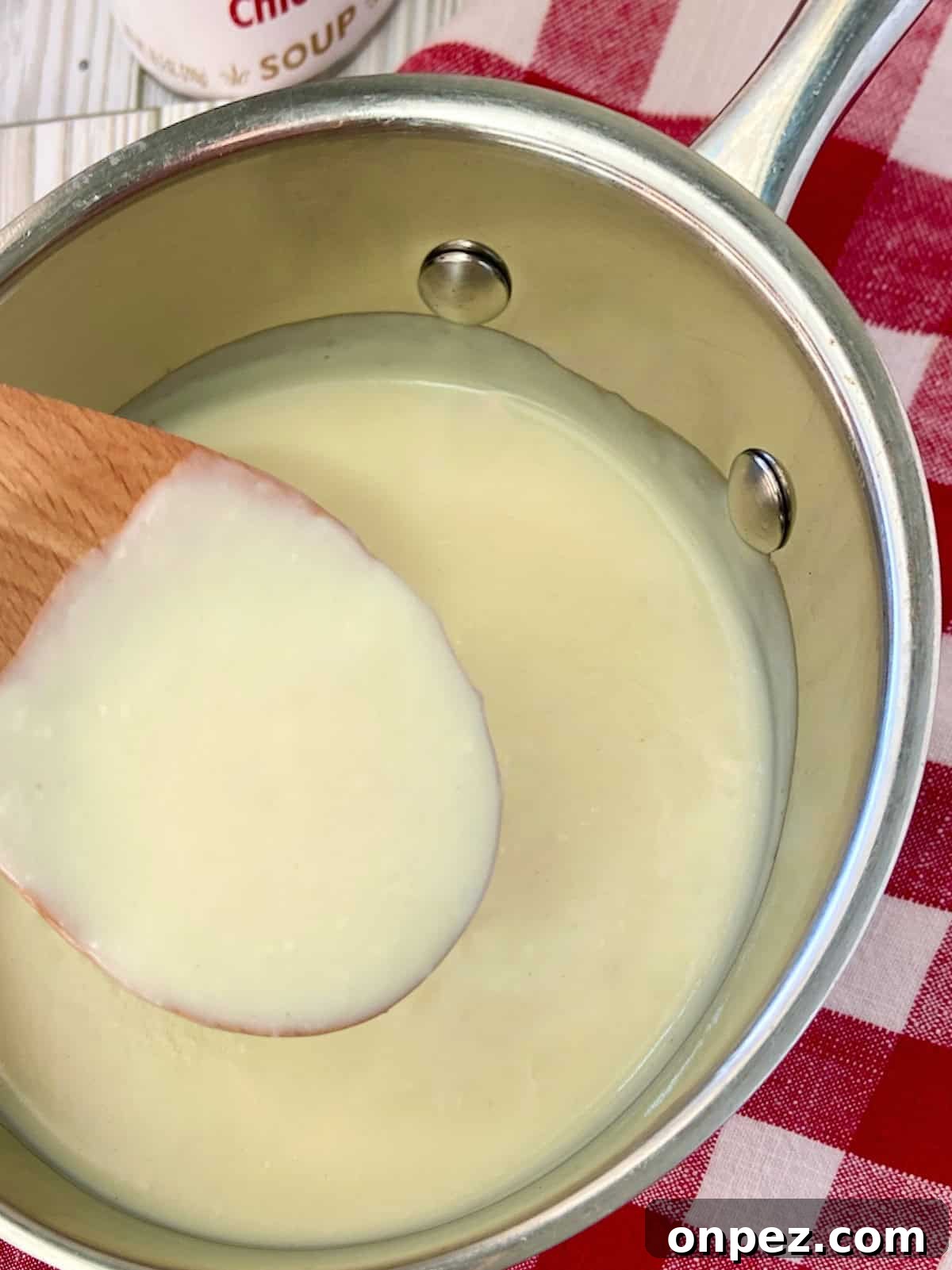 Condensed Cream of Chicken Soup from Scratch 4 Condensed cream of chicken soup on wooden spoon.