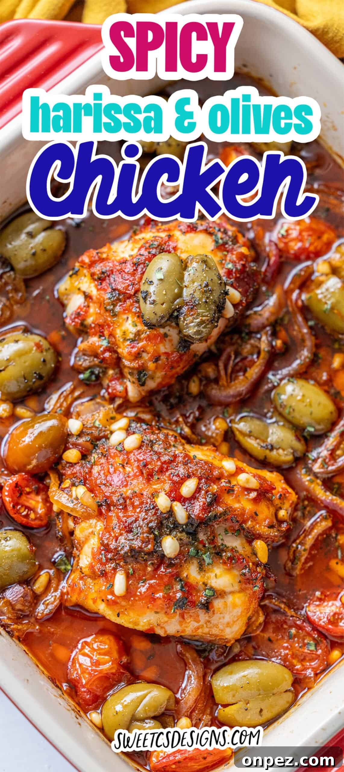 Harissa Baked Chicken with Smashed Olives: Baked chicken thighs topped with spicy harissa sauce, smashed green olives, pine nuts, and tomatoes in a white dish.