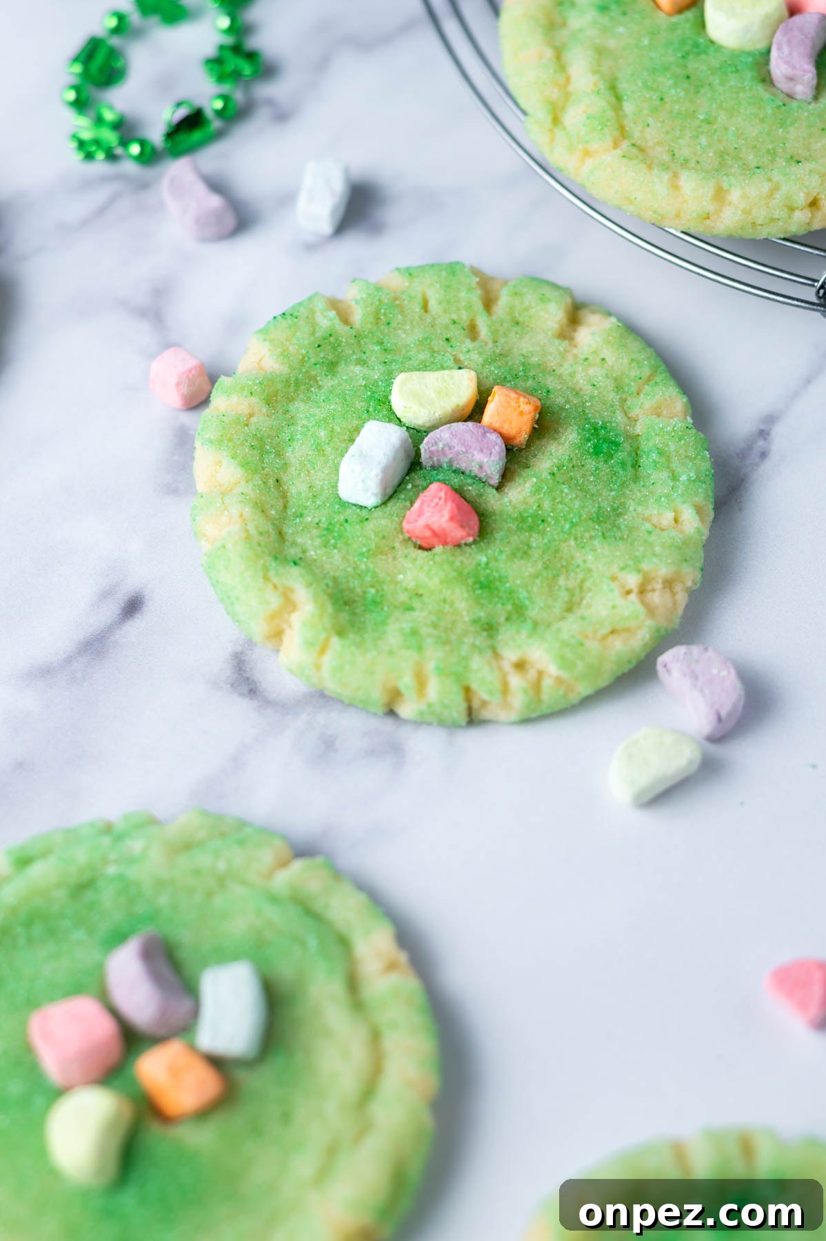 St Patricks Day Sugar Cookies with Festive Green Icing 3 St Patrick's day sugar cookie on a counter with marshmallows around it