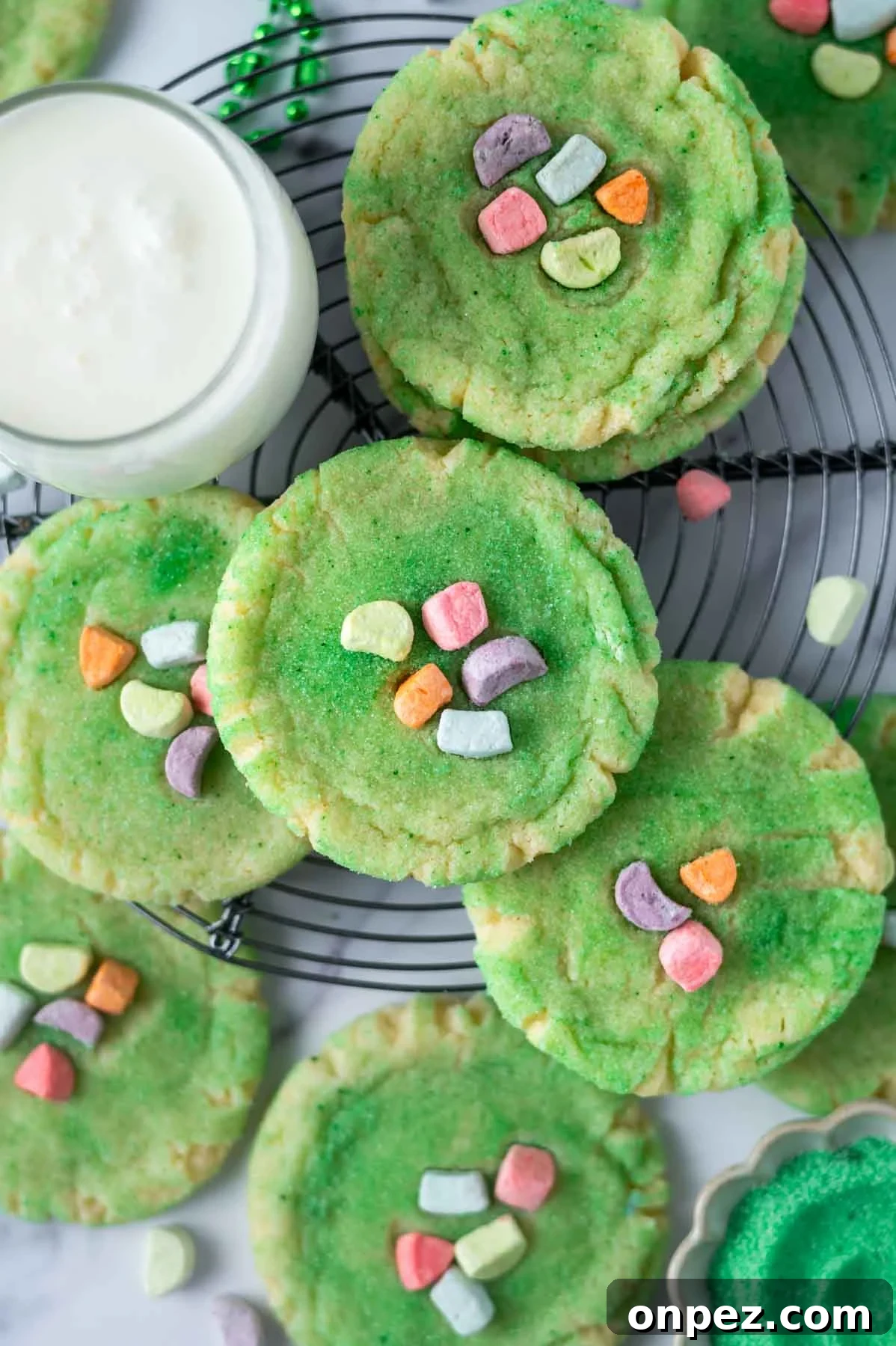 St Patricks Day Sugar Cookies with Festive Green Icing 10 st pattys day sugar cookies on a cooling rack with a glass of milk