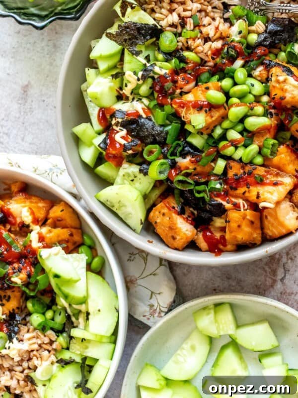 Ceramic bowl with Teriyaki salmon served over rice with toppings.
