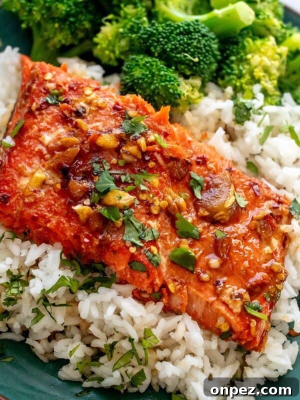 green plate with firecracker salmon on top and broccoli.