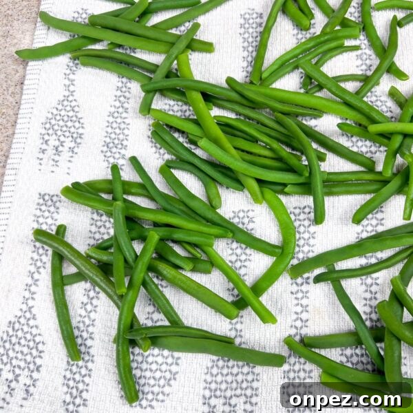 How to Freeze Green Beans for Freshness All Year 7 blanched green beans on clean towel