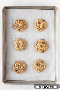 Baked kitchen sink cookies on a baking sheet.