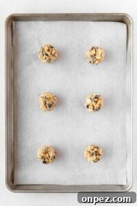 Balls of cookie dough on a baking sheet.