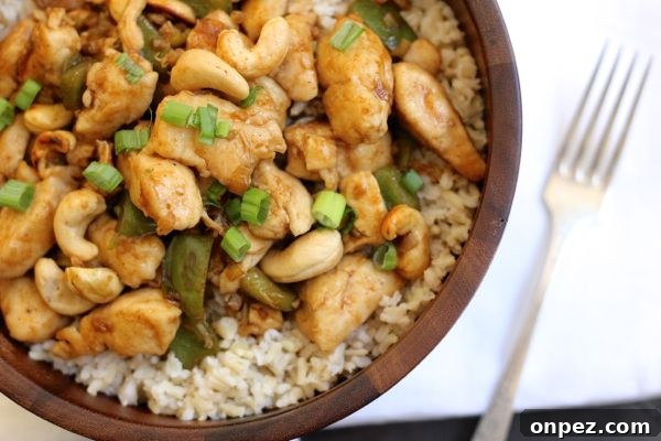 Healthy Cashew Chicken with Brown Rice with chicken, peppers, onions, and cashews