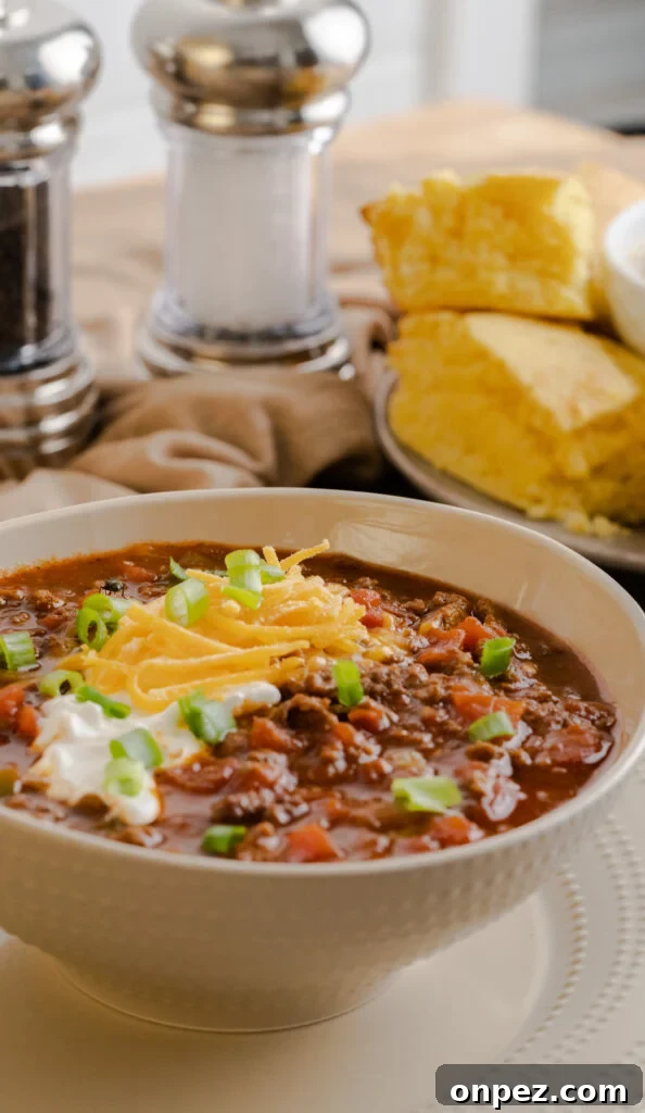 Instant Pot Chili Without Beans 2 Bowl of keto Instant Pot no-bean chili garnished with sour cream and shredded cheese.