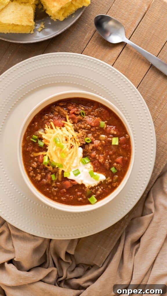 Instant Pot Chili Without Beans 3 Low carb chili topped with sour cream, shredded cheese, and scallions.