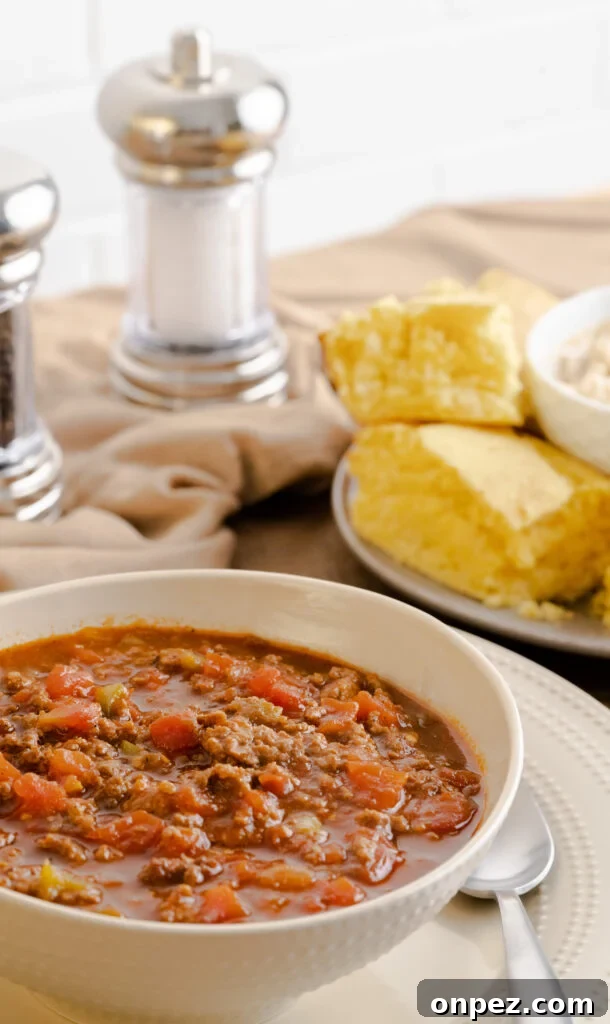 Instant Pot Chili Without Beans 4 Bowl of no bean chili served in a beige bowl with a side of cornbread.