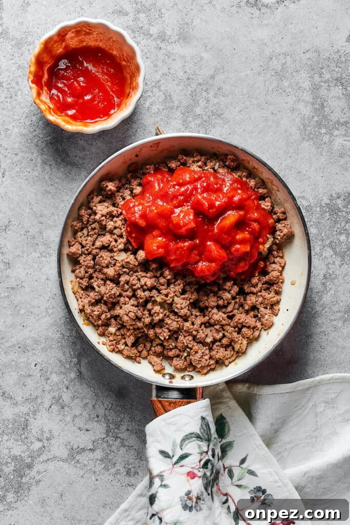 Meat sauce ingredients in a skillet.