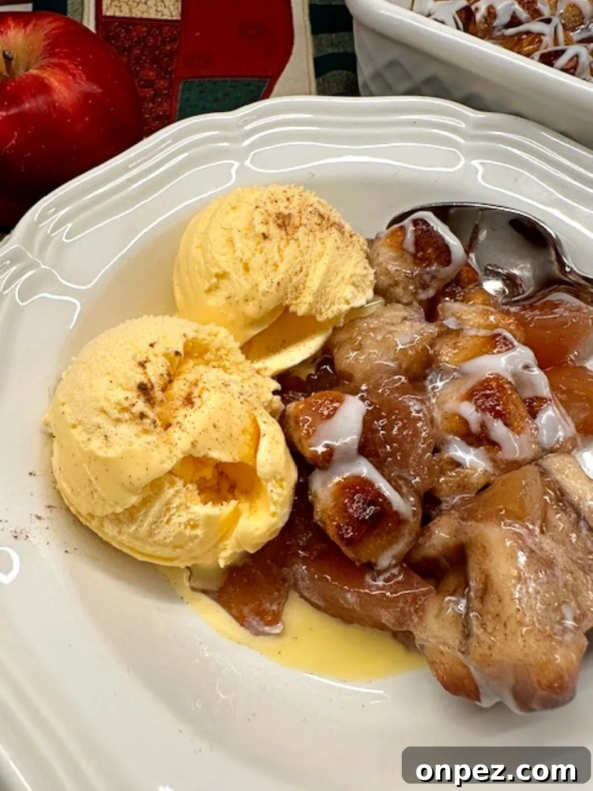 2-ingredient apple coffee cake made with cinnamon rolls and apple pie filling, drizzled with icing.