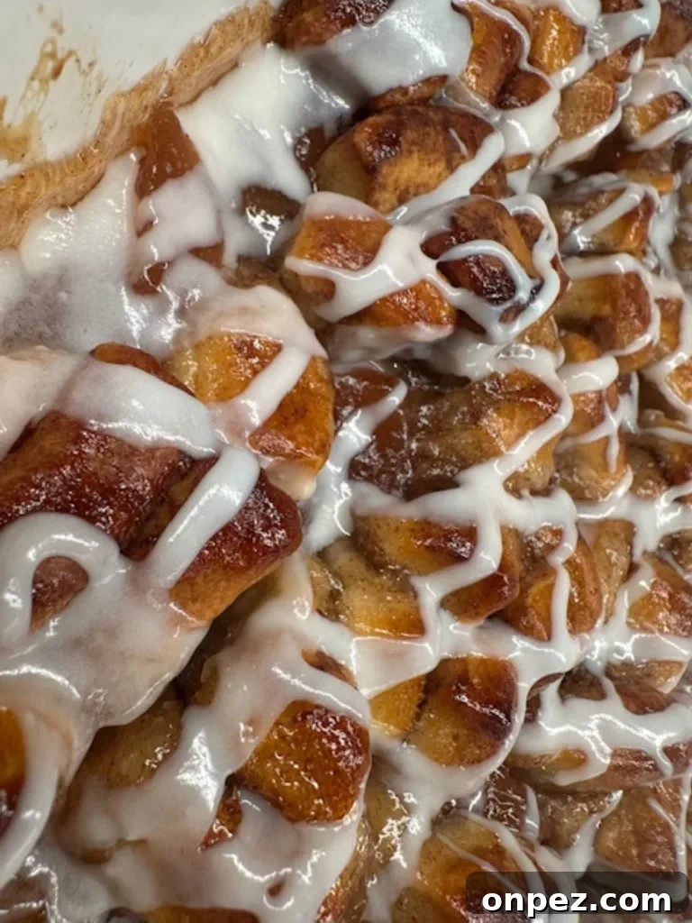 close up of warm apple coffee cake drizzled with yummy cream cheese icing