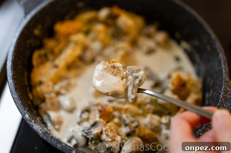 Smothered Chicken in Creamy Mushroom Sauce 3 image of smothered chicken in a rich whole mushroom gravy