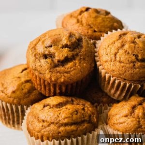 Pumpkin Chocolate Chip Muffins Recipe 7 Pumpkin chocolate chip muffins stacked on a plate.