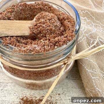DIY Taco Seasoning Mix: Homemade Spice Blend 11 A small jar full of taco seasoning with a spoon on top and a napkin.