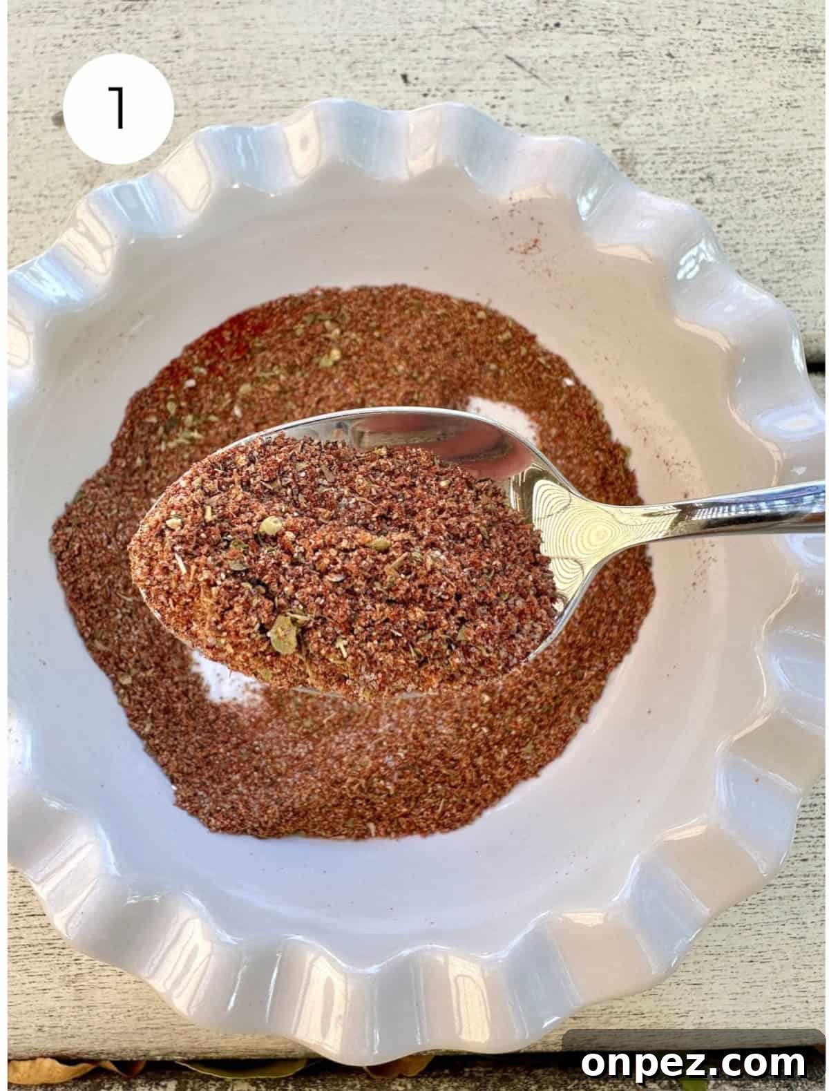 DIY Taco Seasoning Mix: Homemade Spice Blend 5 Blended seasoning in a small bowl with a spoon.