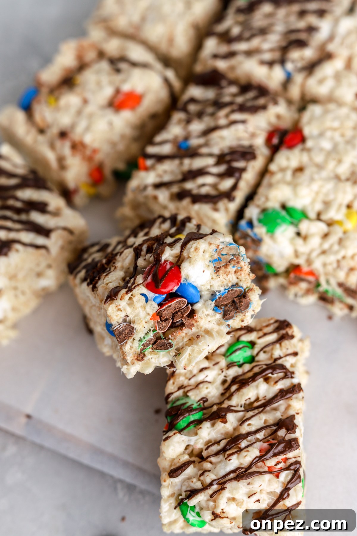 M&M Rice Krispie Treats Recipe 2 Rice krispie treats with M&Ms and chocolate on top.