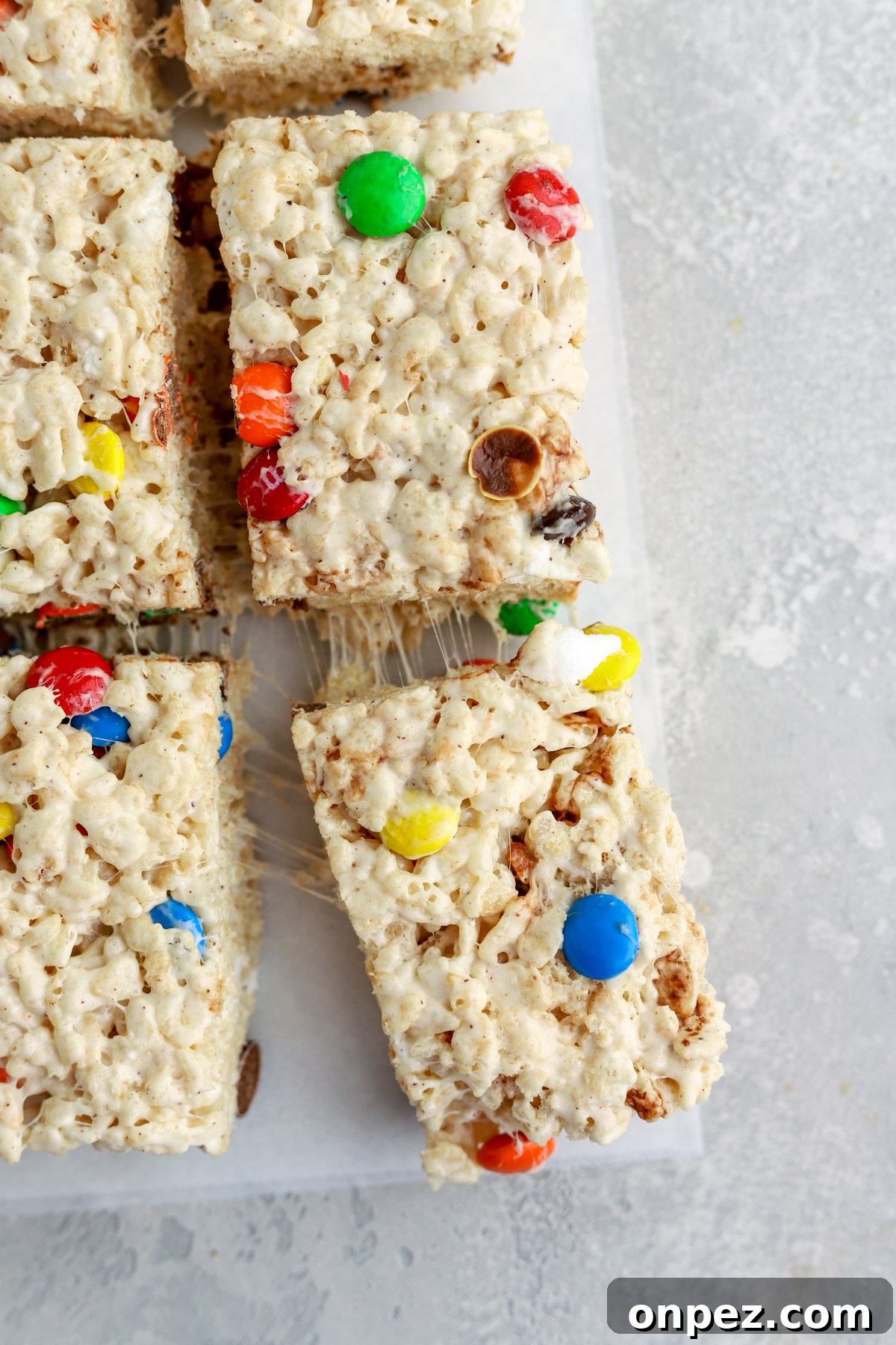 M&M Rice Krispie Treats Recipe 3 Rice krispie treats with M&Ms cut into pieces.