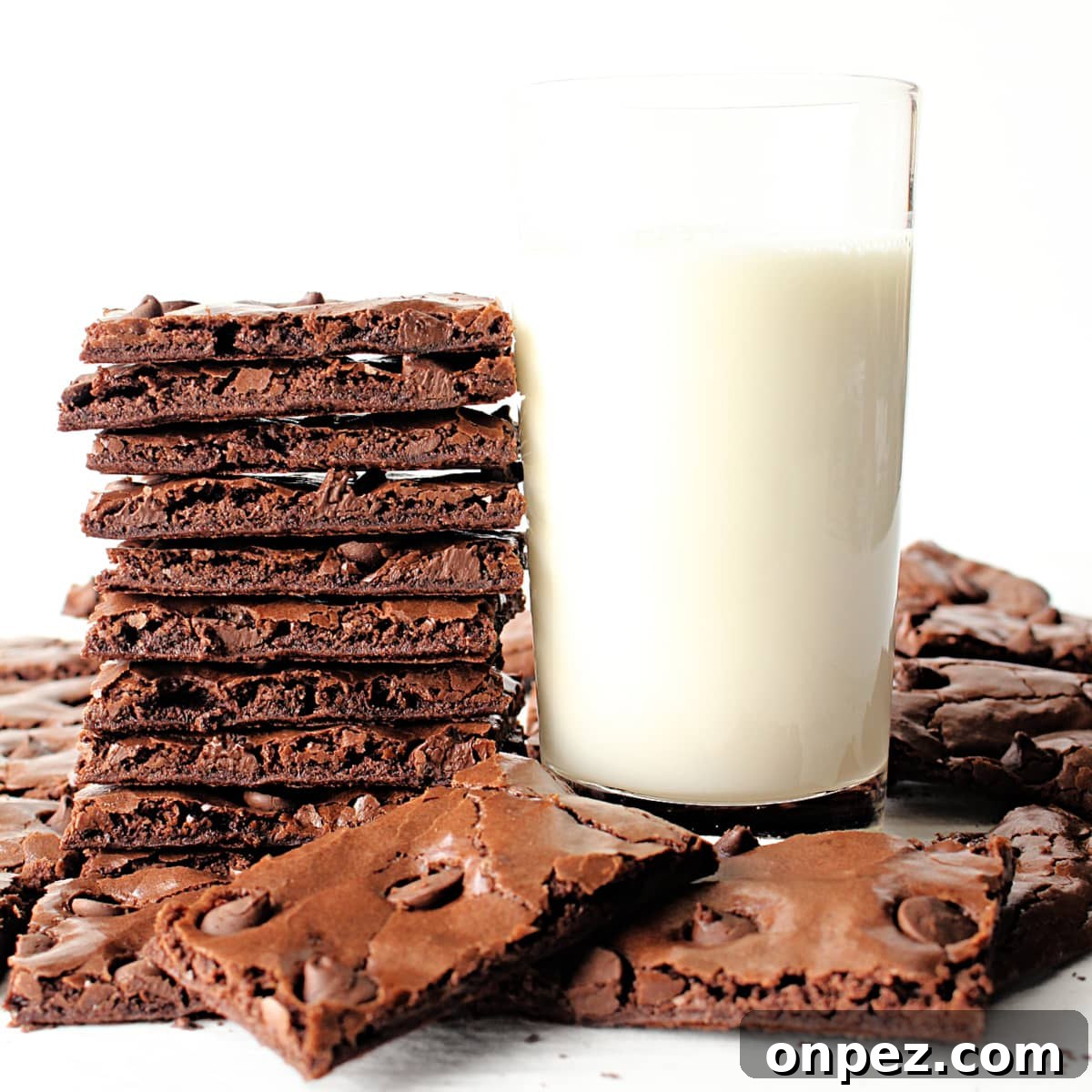 Gluten-Free Brownie Brittle: Crispy Chocolate Crunch 5 Stack of thin brownie brittle next to a glass of milk.