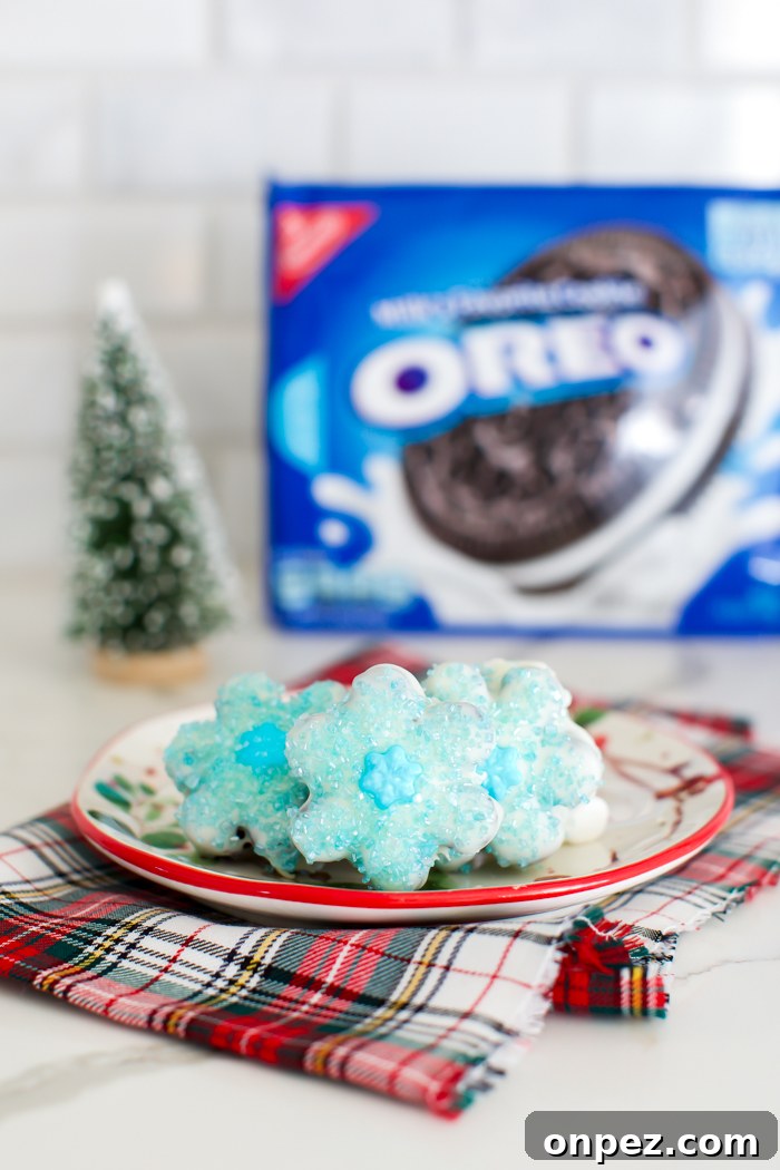Christmas Oreo Truffles: Festive No-Bake Cookie Balls 6 snowflake shaped oreo truffles dipped in white chocolate and decorated with blue sprinkles
