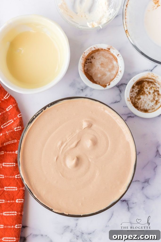 Folding condensed milk into whipped cream for mousse.