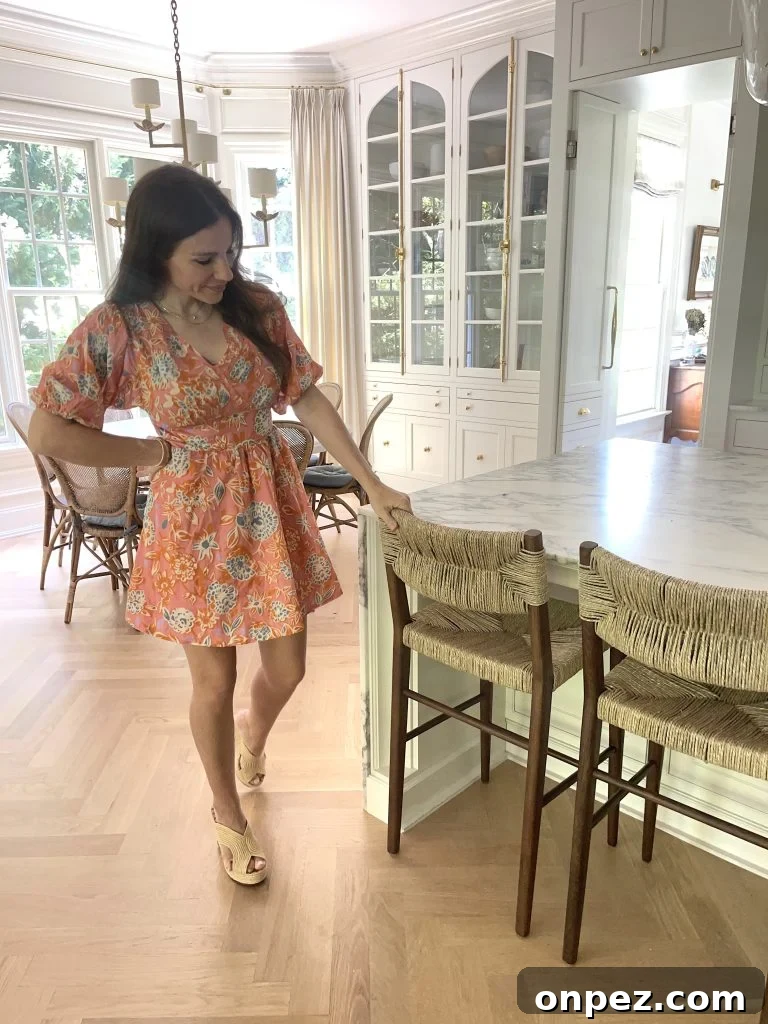 Serena and lily Portside stool with a woman reviewing them
