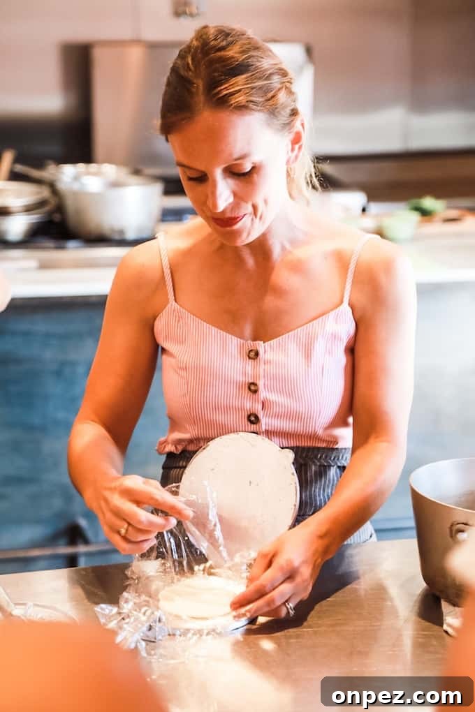 How to Make Authentic Corn Tortillas at Home 3 Woman making corn tortillas with a tortilla press.