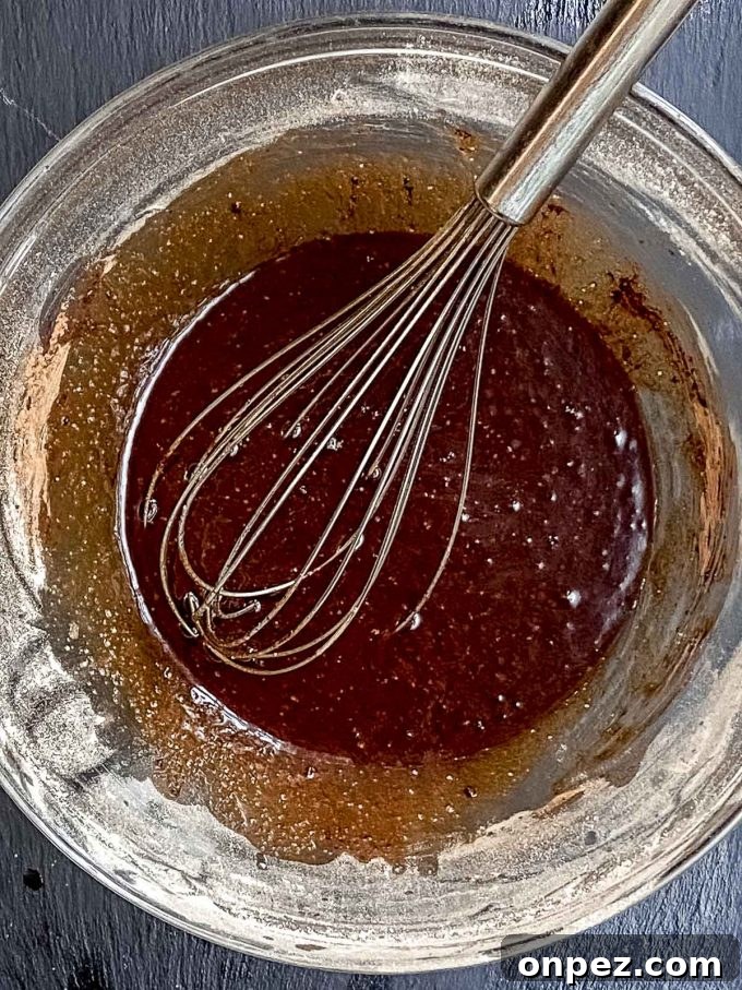 Whisking egg or flax egg, coconut oil, sugar, vanilla and cocoa powder in a bowl