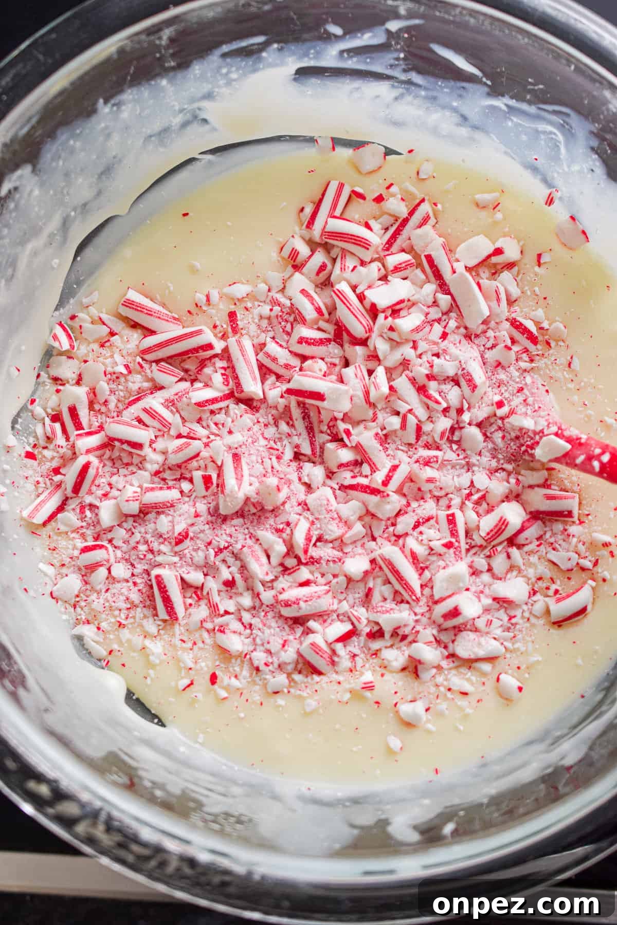 Candy canes are added to the bowl.