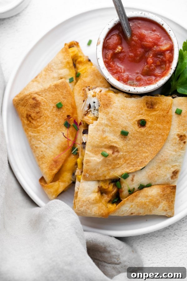 sheet pan chicken quesadillas cut on a plate. 